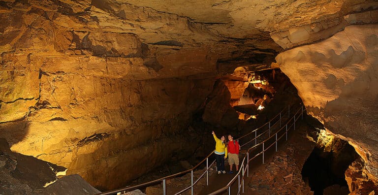 Jessie Carson and Burak Lacinier gaze at the broad vista and rocky breakdowns of Thanksgiving Hall in Mammoth Cave, near the cave's Frozen Niagara area. Image taken in 2007. Image is a panoramic composite.
